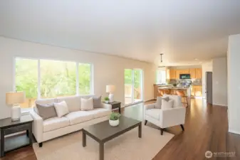 The expansive picture window captures serene backyard and green space views, seamlessly bringing the outdoors inside - Virtually staged to inspire your vision of the space.