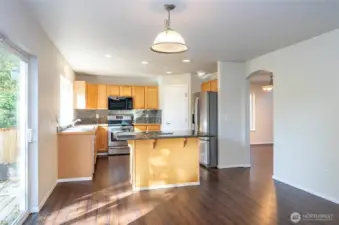 Spacious kitchen designed for easy meal preparation, with an archway that seamlessly connects to the dining and living areas.