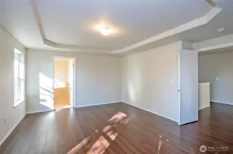 Primary suite with a view toward the entrance of the luxurious five-piece ensuite.