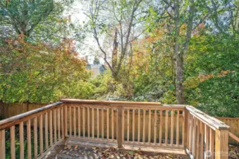 From the deck, enjoy added privacy with the green space just beyond the fence.