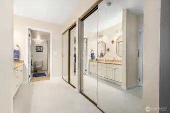 Primary suite entry with dual mirrored closets leading to an updated bath.