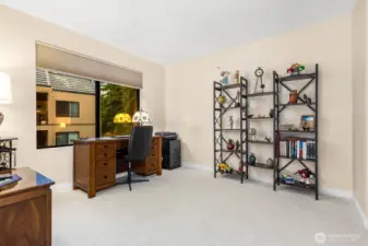 Large office nook framed by a wide window—ideal for working or reading with natural light.