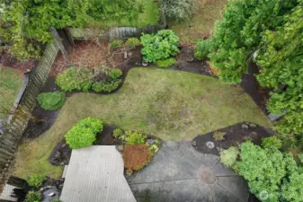 The backyard is ready for outdoor enjoyment with its composite deck, small pond with a fountain and patio space.