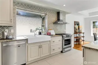 Chef’s kitchen featuring stainless steel appliances and a farmhouse sink, blending timeless style with everyday functionality