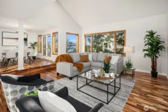 Living and dining spaces connect through french doors to the back deck with captivating sound views.