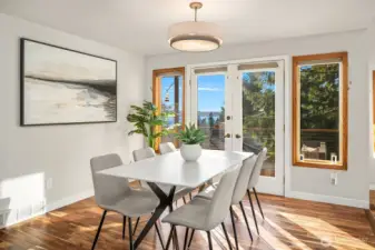 The dining room is bathed in golden light through the french doors.