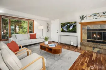 Another view of the family room and warm fireplace. The door shown goes into the spacious attached garage.