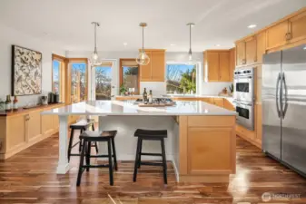 Coffee and wine bar area to the left, double oven and spacious refrigerator on the right. Easy to grill on your deck and bring food in through the glass door to the left of the sink.