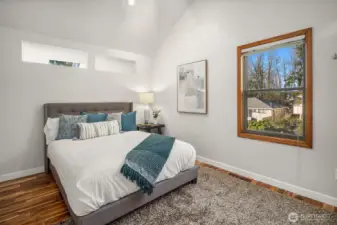 The third bedroom with vaulted ceilings and an extra large closet on the opposite wall is located on the opposite side of the primary suite upstairs, allowing privacy and separation.