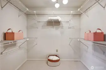 Primary suite walk-in closet. There is an additional large closet in the vanity area of the primary bath.