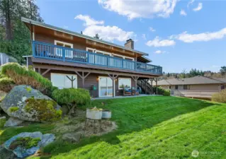 Low maintenance landscaping with and entertaining deck.