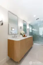 Primary spa-inspired bathroom with custom tile work and frameless glass shower