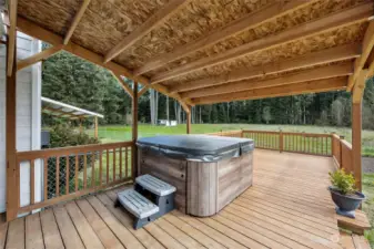 Primary bedroom private deck with hot tub and access to the side yard with beautiful garden in place.