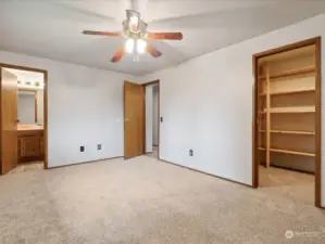 Primary bedroom on main level with attached bathroom and walk-in closet.