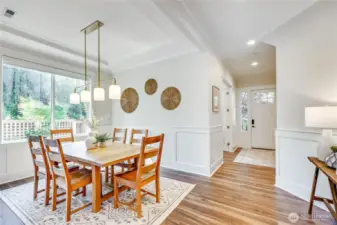 The dining room boasts space for a side table / buffet. Beautiful lighting throughout the home.