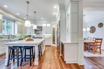 Tons of storage, a fully shelved pantry, a wine fridge, and gourmet appliances from Wolf / Subzero / Asko line the kitchen.