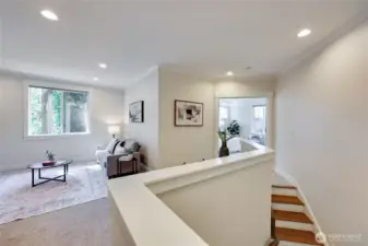 Upstairs landing looks into the primary bedroom and loft.