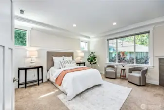 The large primary suite boasts a second fireplace, a 5-piece en-suite, and two closets.
