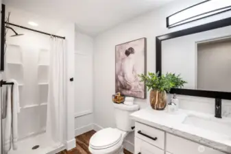 Lower level 3/4 shower with extra wall storage.