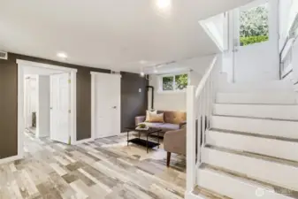 Lower level bonus/family area.  Stairs lead to the kitchen and access to the back deck