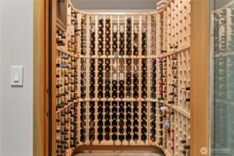 The wine cellar is located in the garage and cooled to 57 degrees and accommodates 300 bottles. Cheers!