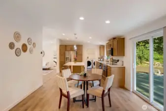 Bright dining area with slider leading to outdoor living