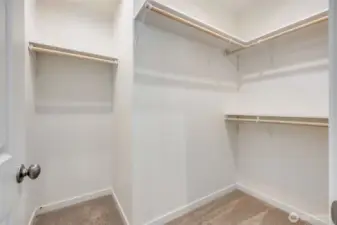 Primary bedroom walk-in closet
