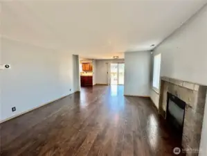 Open living room with laminate floors and gas/propane fireplace.