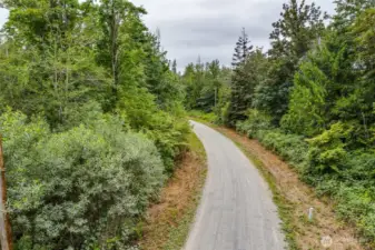 this is 84th which splits this parcel with best building area on left at crest of hill.