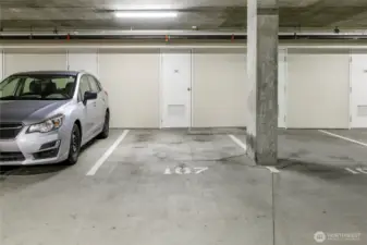 Level G2 parking space #107 with private storage locker behind. Owners are allowed to purchase an EV charging station at their space with HOA approval.