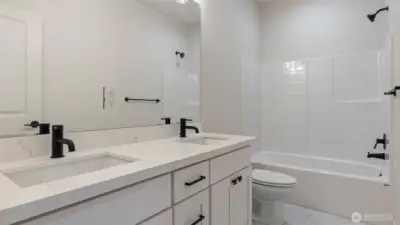 Main Bath has big vanity quartz counters, dual undermount sinks & tile flooring.