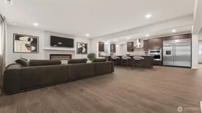 Great room view from 2nd main entry area.  Check out the cozy fireplace!  Actual home is under construction and materials, colors, and finishes will vary. See site agent for details.