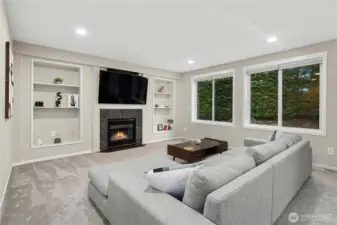Great room with gas fireplace and built-in shelves.