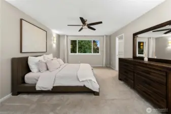 Primary bedroom with French doors, walk-in closet and en-suite bath.
