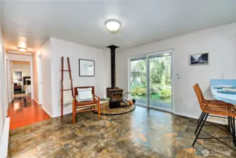 Cozy wood stove just off the kitchen, with sliding door out to back yard.