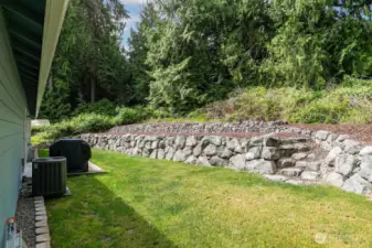 Tiered backyard which is ready for your ideas, plenty of area for gardening.