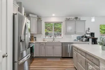 A kitchen where you can enjoy preparing meals. Soft pull cabinetry and take in the views.