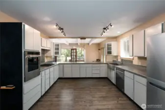 Ample kitchen has new appliances by KithenAid installed by Judd & Black. Wall oven, propane range, dishwasher and KitchenAir 4-door refrigerator. Waterproof laminate flooring in kitchen and eating area. New track ligthing installed.