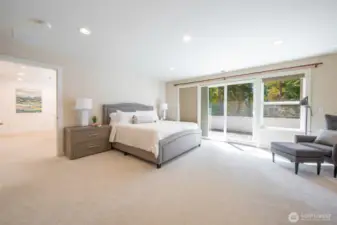 The second floor houses the primary bedroom with private balcony, high ceilings, stone fireplace, walk-in closet and five-piece bath.