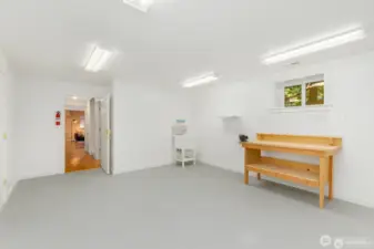 This extra finished room in the lower level is perfect for an exercise room, craft area, storage, or future kitchen for a M-I-L too!