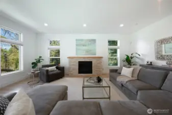 Entertain and relax in style in this spacious liivng room complete with stone fireplace, walls of windows, newly refinished hardwood floors and soaring ceilings.