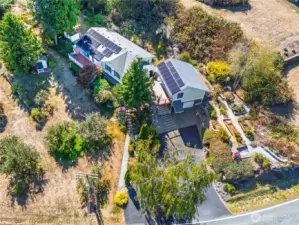 You will love this setting! That comes with a view!  38 Solar Panels, 3 out buildings, vegetable garden and privacy.