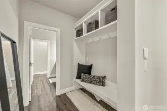 Mudroom with Built in bench and access to powder room