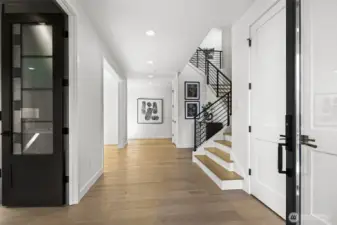 Open and welcoming entry foyer with the office on the left. Chaffey Building Group always have exquisite millwork wrapped doorways and windows. Gorgeous warm color to the wide plank engineered hardwoods.