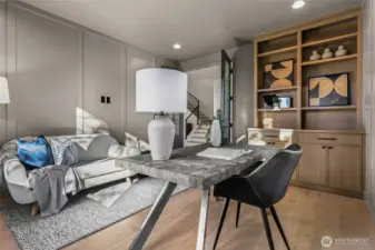 French doors open to a nice size office. Wide-plank engineered white oak hardwood flooring, and rift sawn oak furniture-style built-in cabinets, drawers, and open shelving. Two ceiling speakers with a volume control.