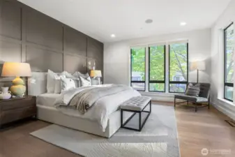 Wonderfully cozy primary bedroom. Boxed pattern accent wall, oversized windows with a mature Dogwood tree that provides softness and privacy. Top-down-bottom-up blinds installed on all windows in this bedroom and bathroom.