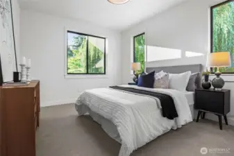 Upper level bedroom enjoys a filtered view and a walk-in closet.