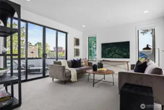 Bonus room soaks in light from the southwesterly double sliding doors and two fixed window panes that lead to the private deck. Filtered Lake Washington and Olympic mountain views. Pre-wired for two ceiling speakers.