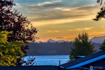 Lake Washington and Olympic Mountains views are zoomed in from from the bonus room windows. Lovely sunset skies are seen from this home.