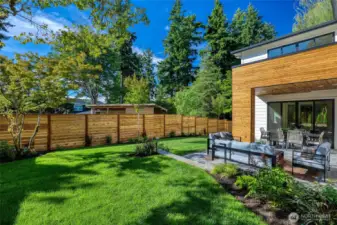 There are so many positives about this home's setting! You must come take a look to experience it for yourself. Soft, level lawn, large outdoor living spaces, and a feeling of stepping into a backyard sanctuary! Professionally landscaped with mature, lush trees, plants, and blooming flowers. Smart irrigation control system, LED accent lighting, and the fully-enclosed yard offer a unique feeling of privacy even though you are moments from the heart of Kirkland.